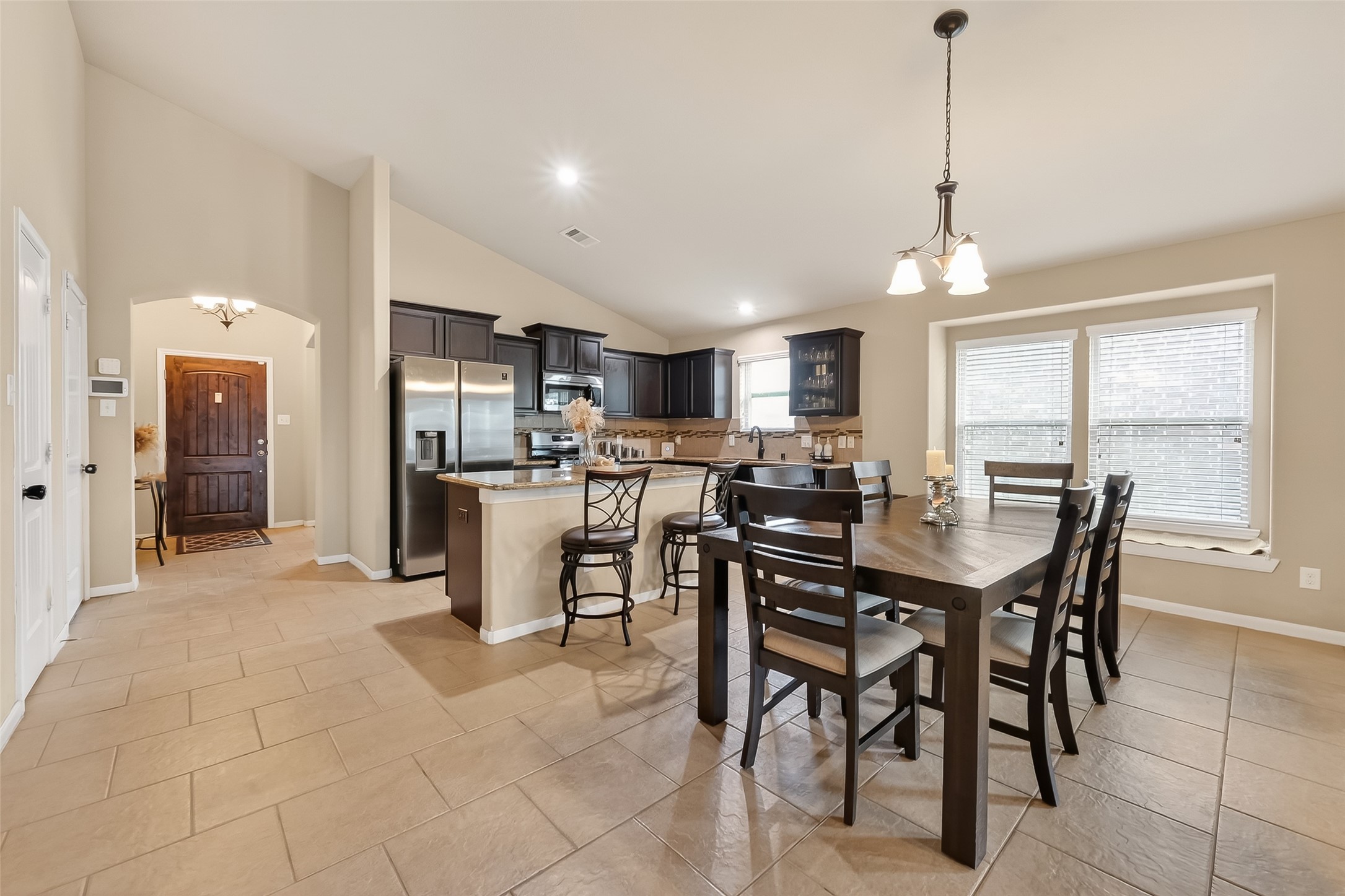 5919 Micah Lane Rosenberg, TX 77471 - Photo 16 of 39 A bright, open dining space that flows seamlessly into the kitchen, creating an easy, connected layout. Large windows bring in plenty of natural light, giving the area a warm and welcoming feel that’s perfect for everyday meals or gathering with others.