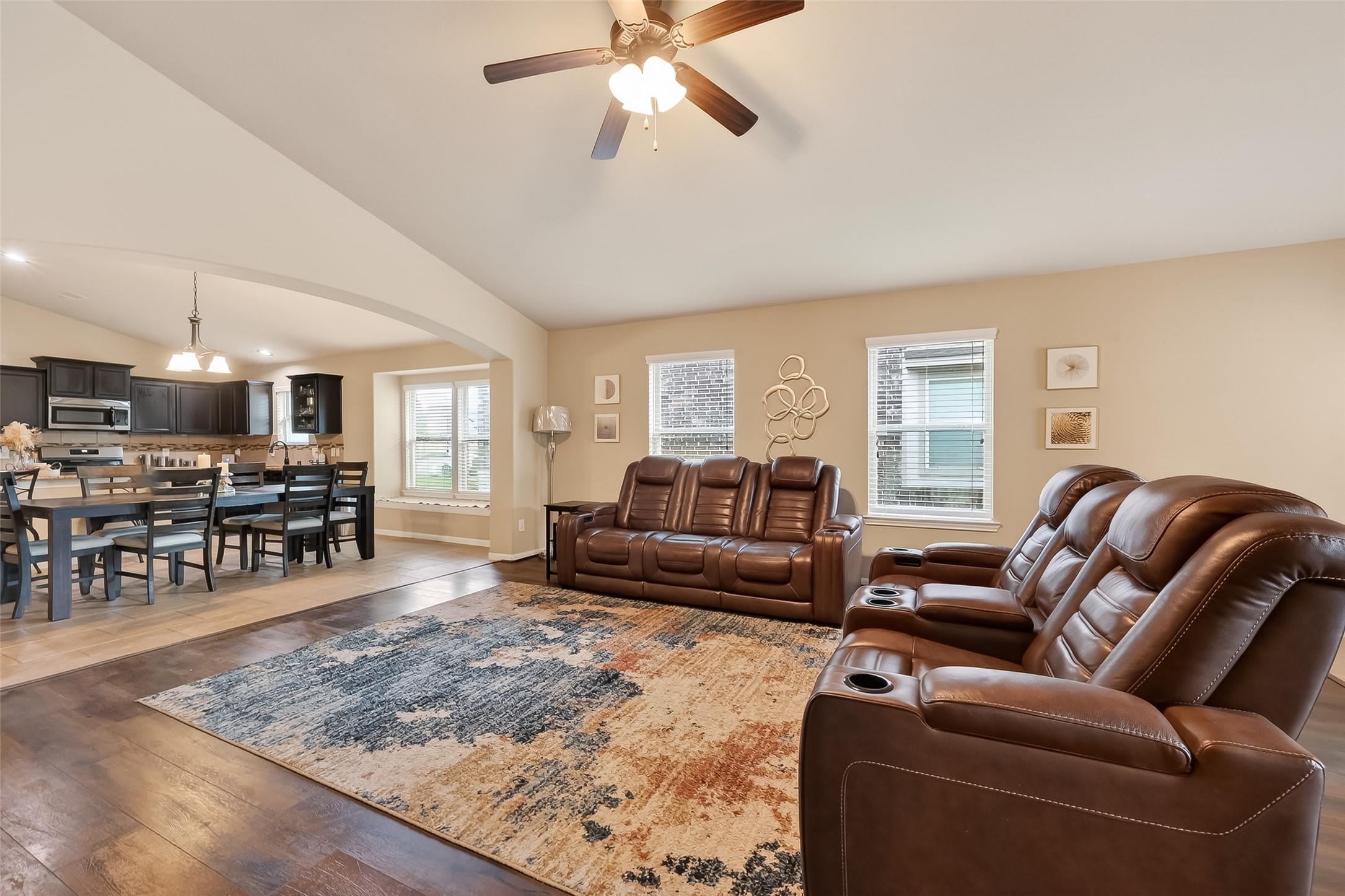 5919 Micah Lane Rosenberg, TX 77471 - Photo 19 of 39 Open living area with high ceilings and natural light from surrounding windows, flowing easily into the dining space