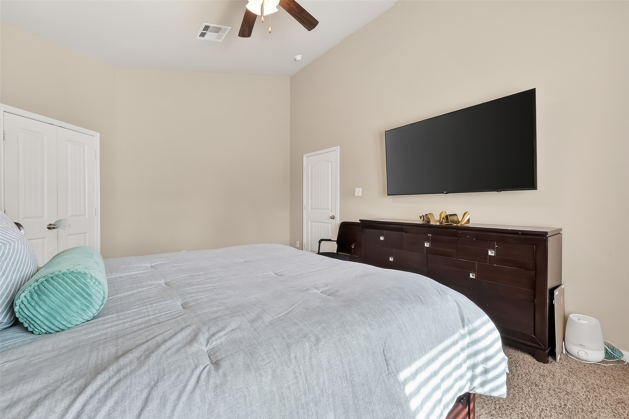 5919 Micah Lane Rosenberg, TX 77471 - Photo 24 of 39 Comfortable primary bedroom with a vaulted ceiling and gentle natural light, offering a relaxed and inviting feel