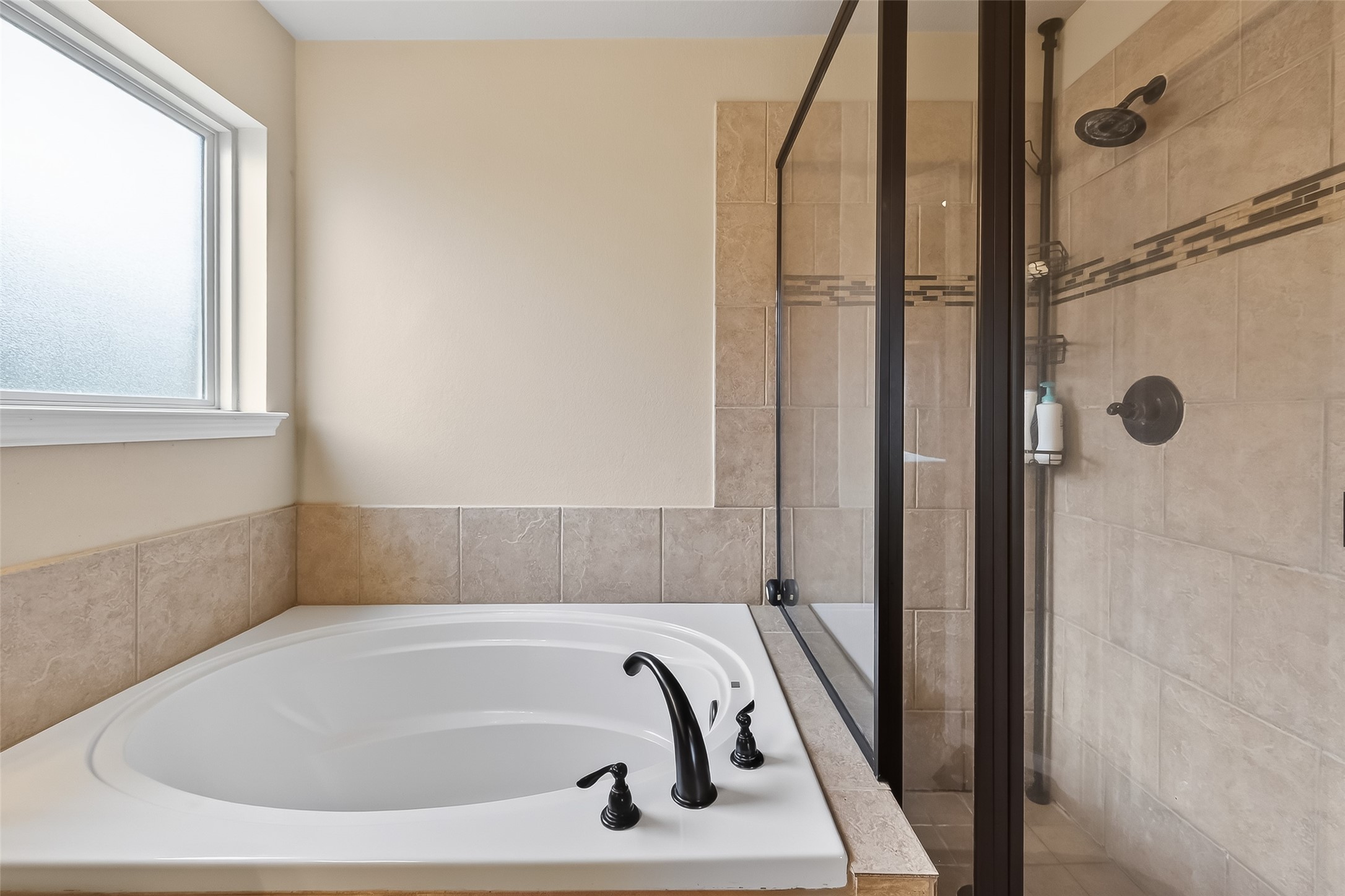 5919 Micah Lane Rosenberg, TX 77471 - Photo 26 of 39 Primary bathroom featuring a separate tub and shower with a window that brings in natural light