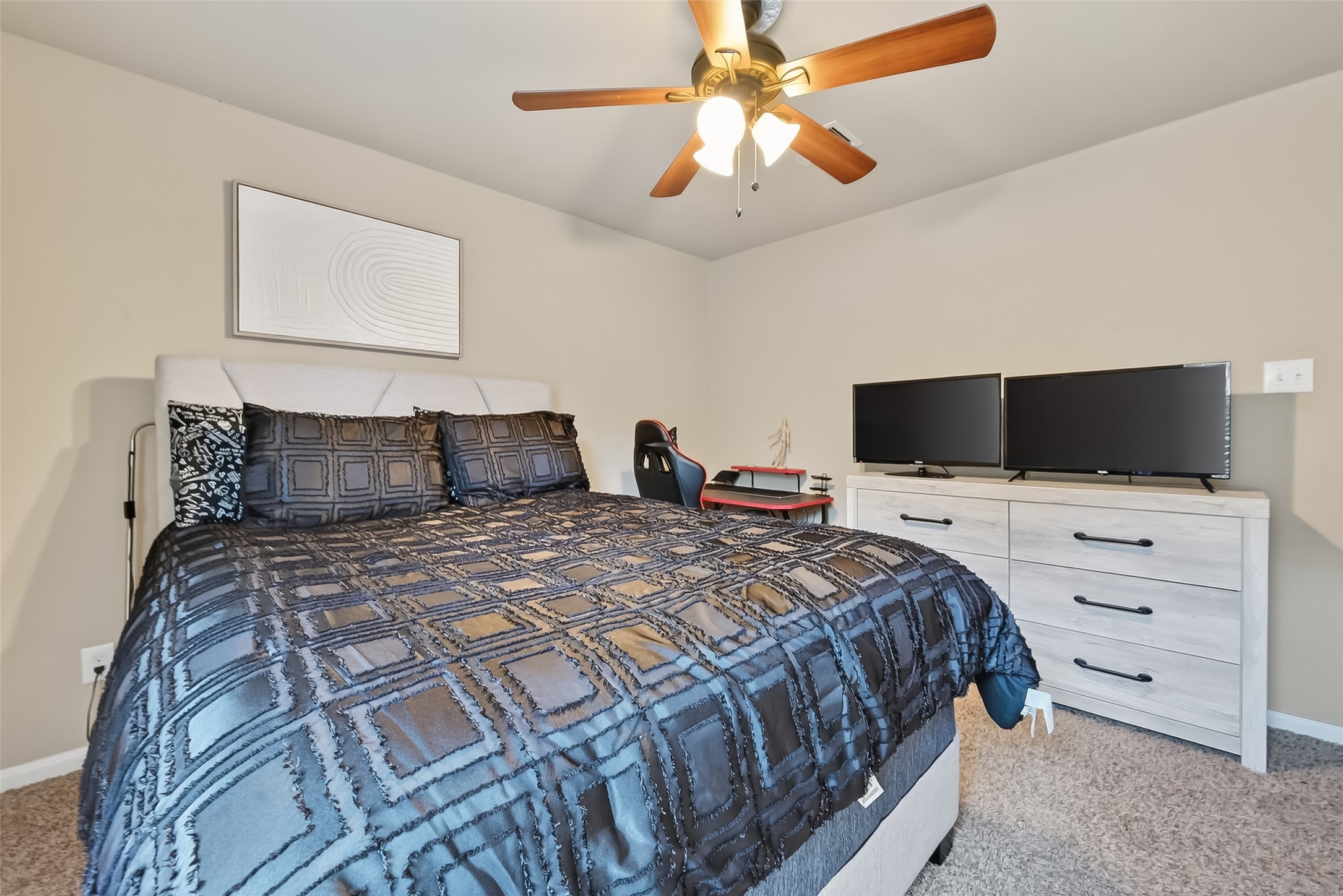 5919 Micah Lane Rosenberg, TX 77471 - Photo 28 of 39 A warm and inviting bedroom with a spacious feel, complete with plush carpeting and a ceiling fan for added comfort