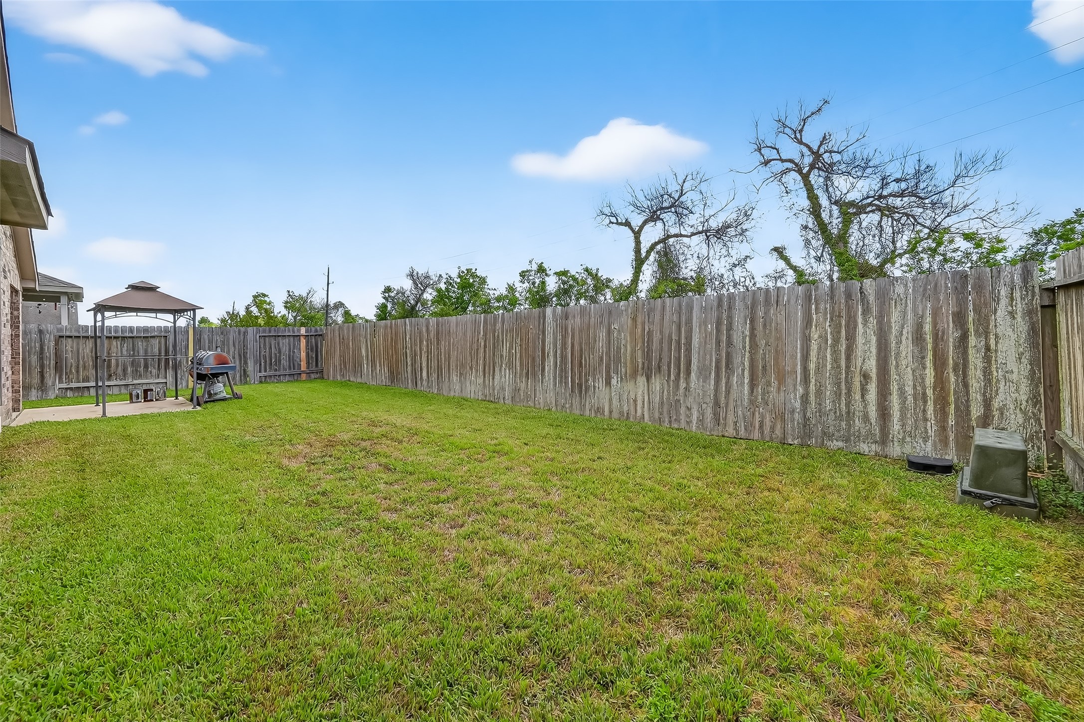 5919 Micah Lane Rosenberg, TX 77471 - Photo 39 of 39 Spacious backyard with well-maintained grass and plenty of room to enjoy the outdoors. It’s a quiet, private retreat that feels open and peaceful from every corner