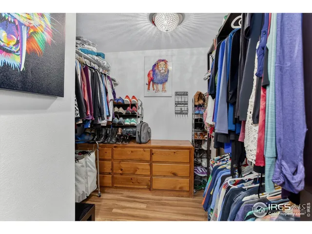 a view of walk in closet with clothes