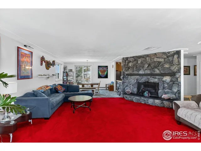 a living room with furniture a fireplace and a table