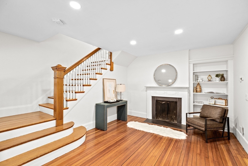 90 Brook Street Wellesley, MA 02482 - Photo 17 of 40 a living room with wooden floor and a fireplace