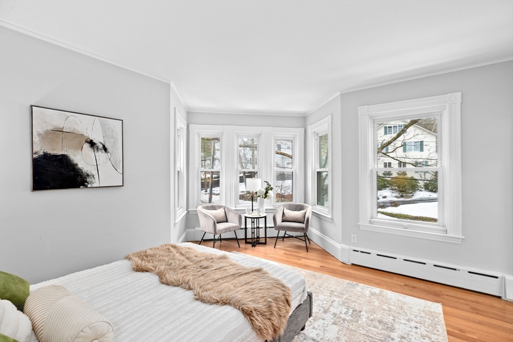 90 Brook Street Wellesley, MA 02482 - Photo 20 of 40 a bedroom with a bed and a chair