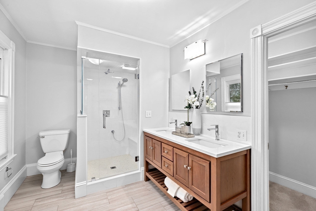 90 Brook Street Wellesley, MA 02482 - Photo 23 of 40 a bathroom with a double vanity sink toilet and shower