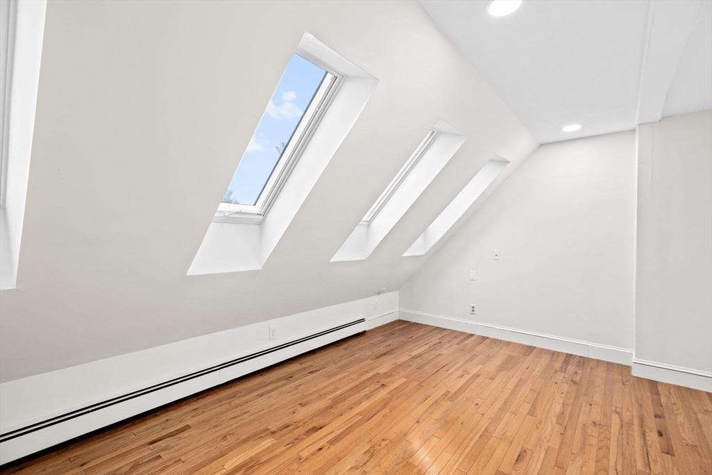 90 Brook Street Wellesley, MA 02482 - Photo 32 of 40 an empty room with wooden floor and windows