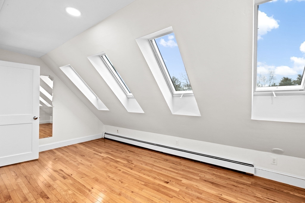 90 Brook Street Wellesley, MA 02482 - Photo 34 of 40 a view of an empty room with wooden floor and a window