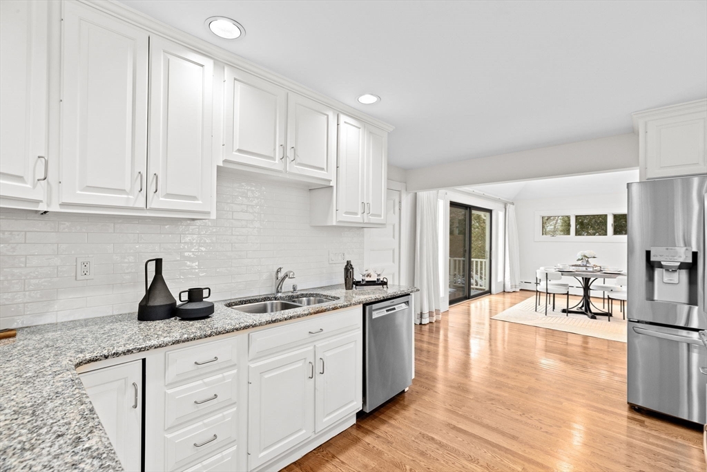 90 Brook Street Wellesley, MA 02482 - Photo 7 of 40 a kitchen with granite countertop white cabinets and white appliances