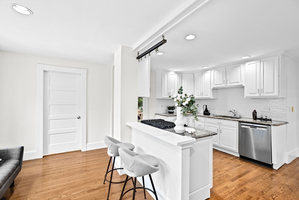 90 Brook Street Wellesley, MA 02482 - Photo 8 of 40 a kitchen with granite countertop a sink cabinets and wooden floor