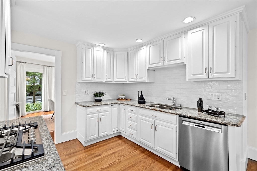 90 Brook Street Wellesley, MA 02482 - Photo 9 of 40 a kitchen with stainless steel appliances granite countertop a sink stove and cabinets