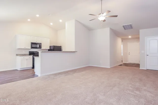 a view of a kitchen with a sink and a refrigerator
