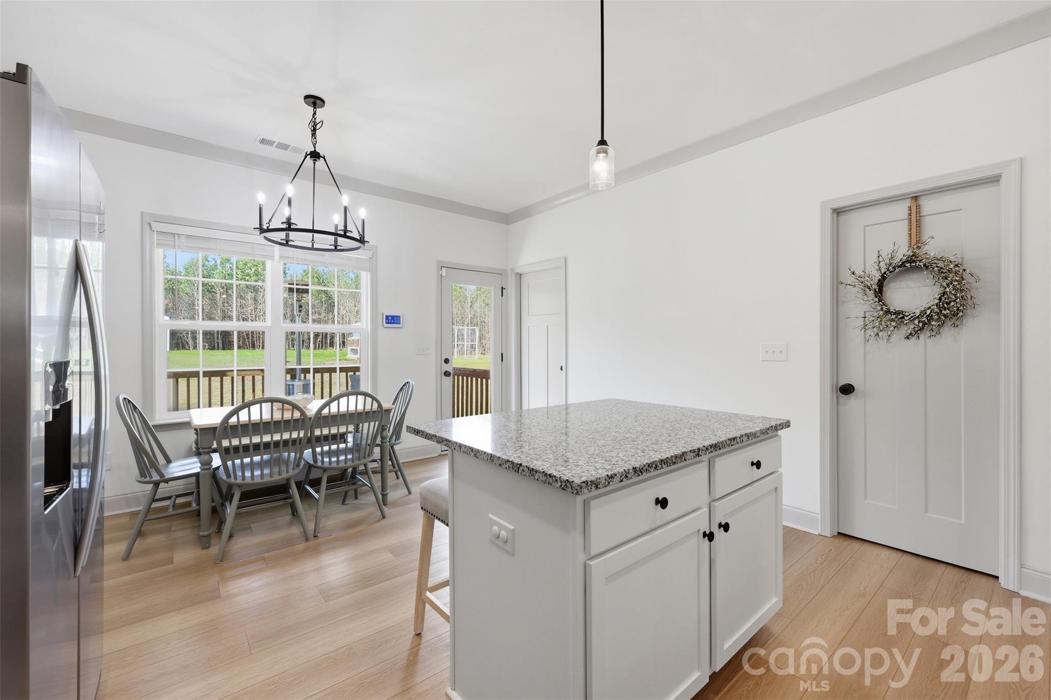 2909 Good Road Clover, SC 29710 - Photo 12 of 37 a dining room with furniture wooden floor a chandelier and a rug