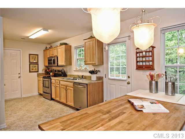 404 Morningside Road Charlotte, NC 28214 - Photo 6 of 14 a kitchen with kitchen island granite countertop a stove a sink and a refrigerator
