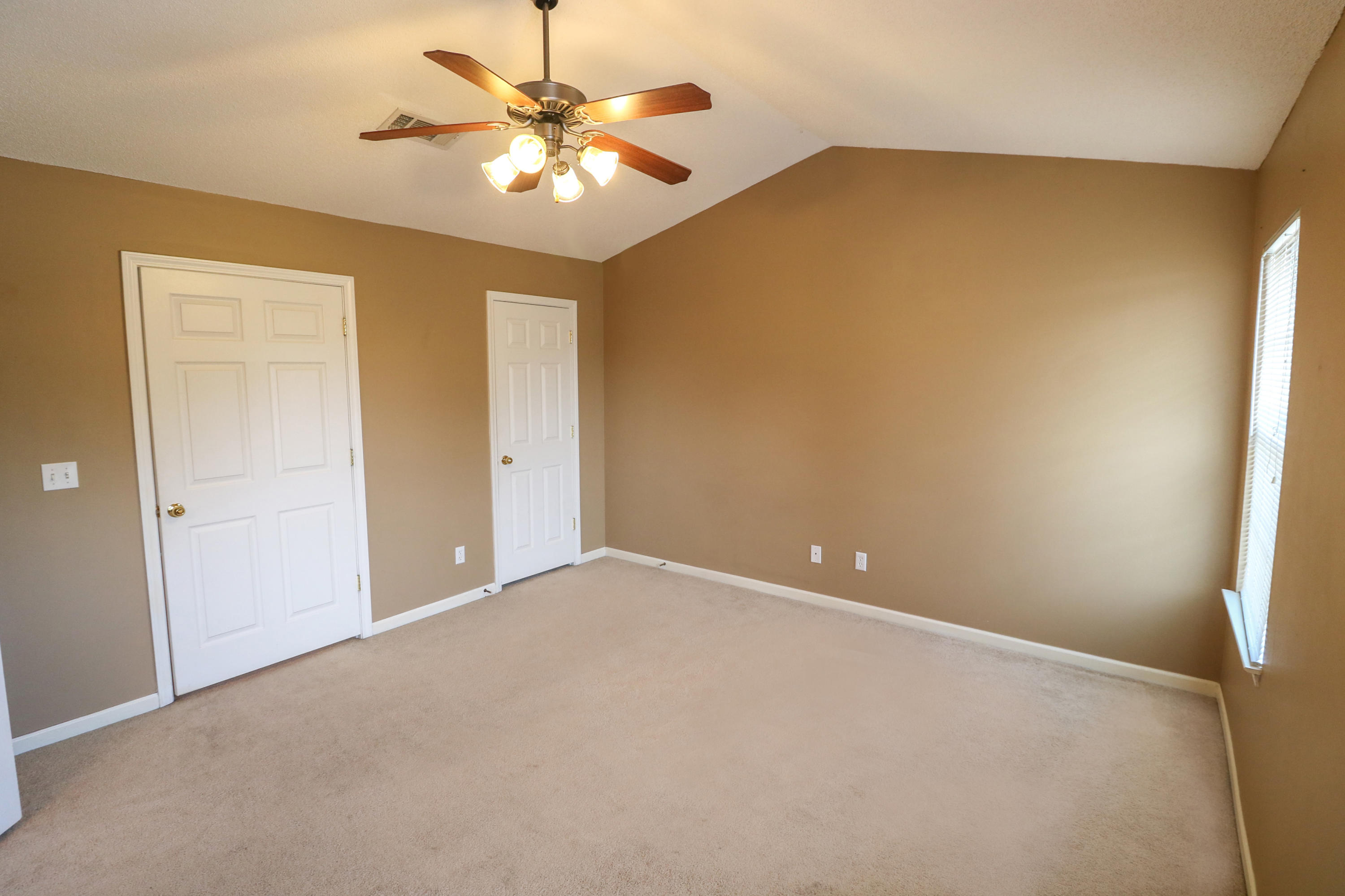 406 Crooked Pine Trail Crestview, FL 32539 - Photo 12 of 22 an empty room with a chandelier fan and a chandelier fan