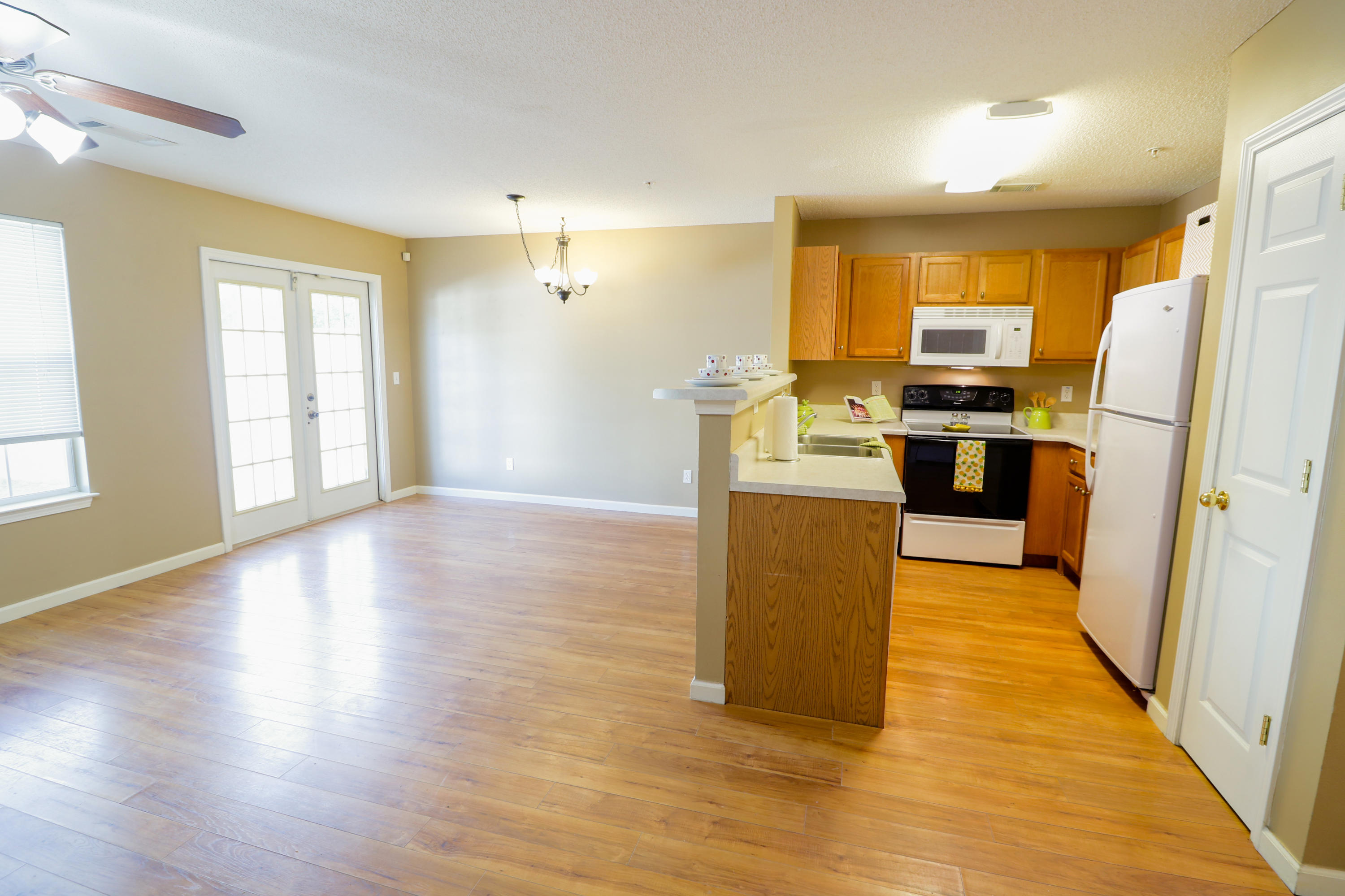 406 Crooked Pine Trail Crestview, FL 32539 - Photo 6 of 22 a kitchen with wooden floors and stainless steel appliances