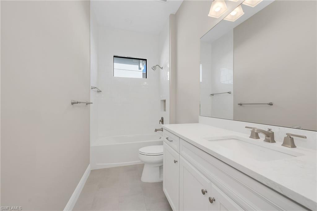 3993 Perseus Street Naples, FL 34120 - Photo 14 of 20 Full bath with vanity and shower / tub combination