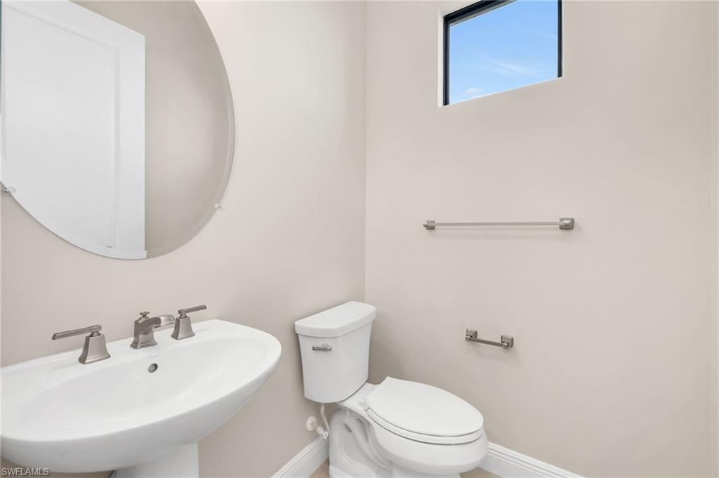 3993 Perseus Street Naples, FL 34120 - Photo 15 of 20 Bathroom with baseboards and a sink