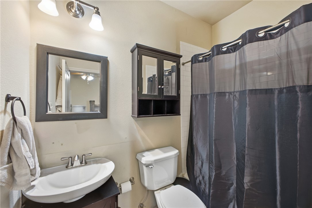 4400 Milam Street Bryan, TX 77801 - Photo 19 of 25 a bathroom with a toilet a sink and mirror