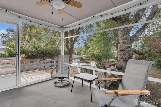 a balcony with wooden floor and outdoor seating