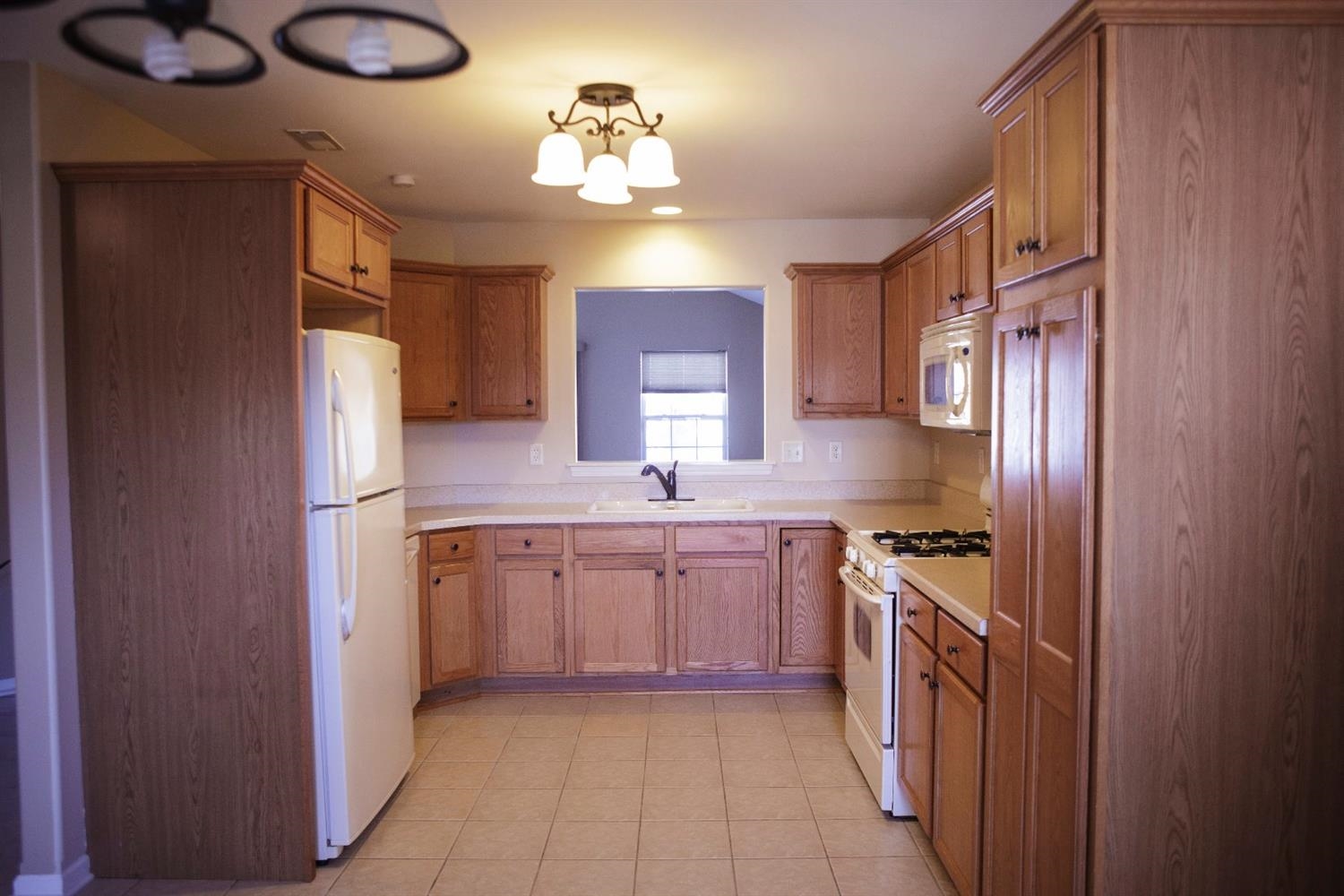 10669 Keystone Lane Crown Point, IN 46307 - Photo 9 of 10 a kitchen with stainless steel appliances granite countertop a refrigerator a sink dishwasher a stove with wooden cabinets and floor