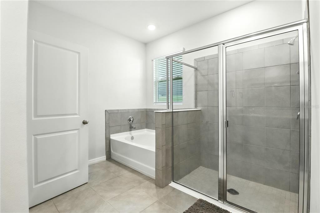 8931 Southwest 49th Circle Ocala, FL 34476 - Photo 15 of 42 a bathroom with a bathtub and shower