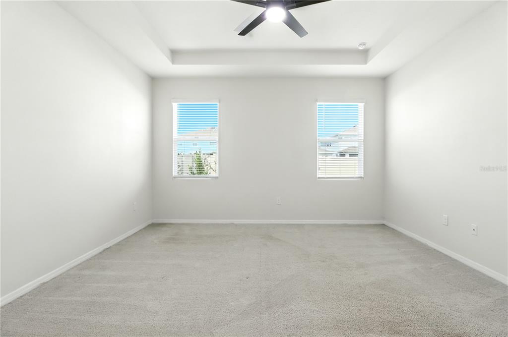 8931 Southwest 49th Circle Ocala, FL 34476 - Photo 18 of 42 an empty room with a window and a ceiling fan