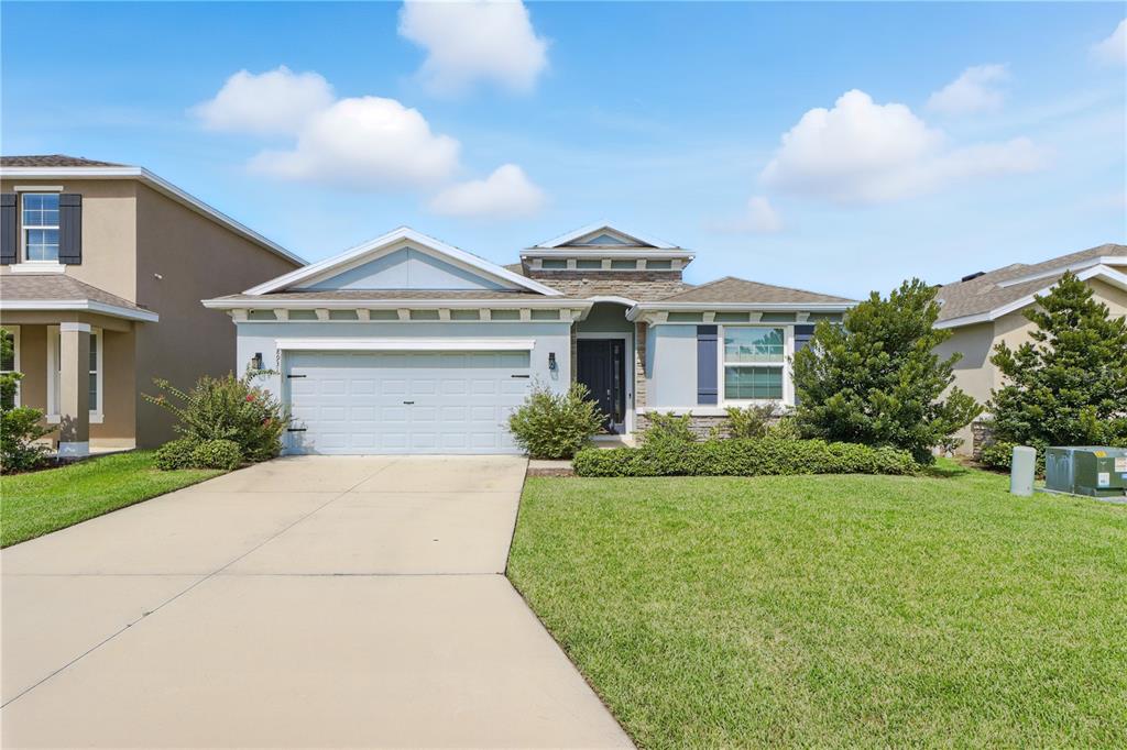 8931 Southwest 49th Circle Ocala, FL 34476 - Photo 2 of 42 a front view of a house with a yard and garage