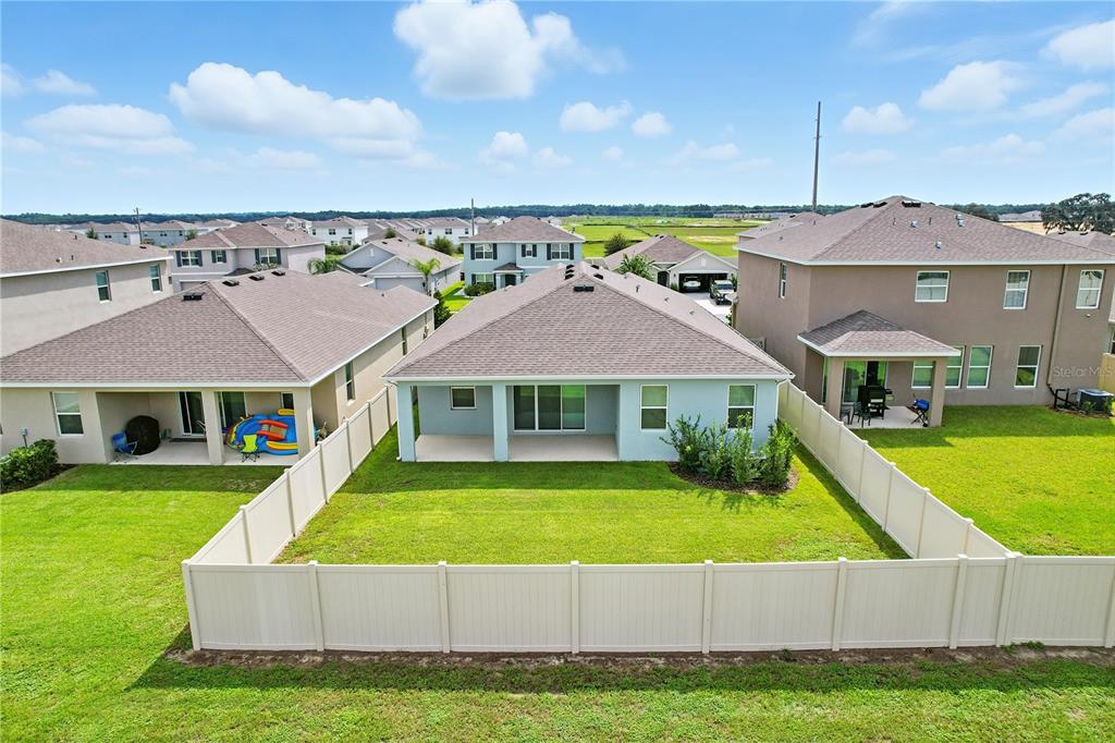 8931 Southwest 49th Circle Ocala, FL 34476 - Photo 23 of 42 a view of a house with a big yard and a large pool
