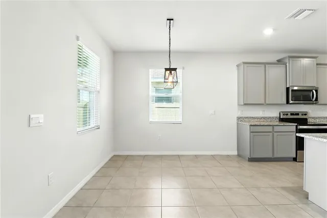 a large kitchen with stainless steel appliances lots of counter top space