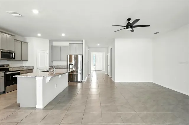 a view of a livingroom with a ceiling fan and window