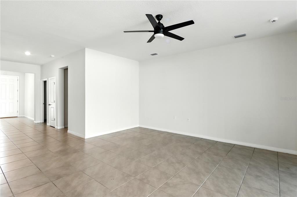 8931 Southwest 49th Circle Ocala, FL 34476 - Photo 28 of 42 a view of a livingroom with a ceiling fan and window