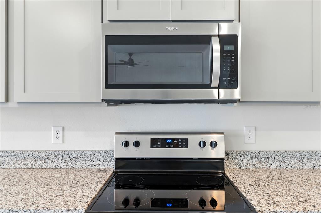 8931 Southwest 49th Circle Ocala, FL 34476 - Photo 30 of 42 a stove top oven sitting inside of a kitchen