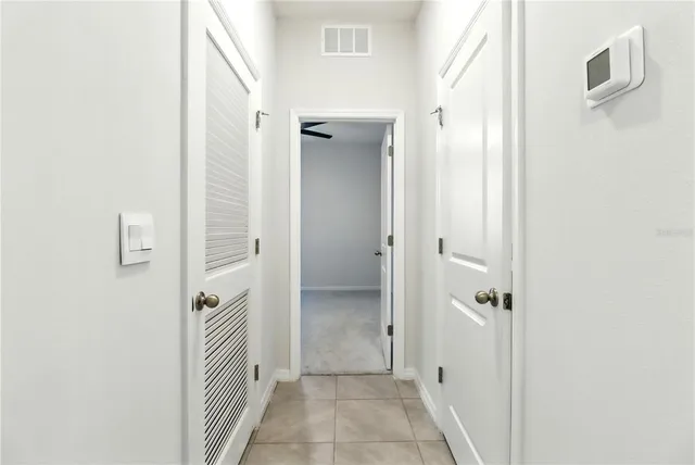 an empty room with windows and cabinet