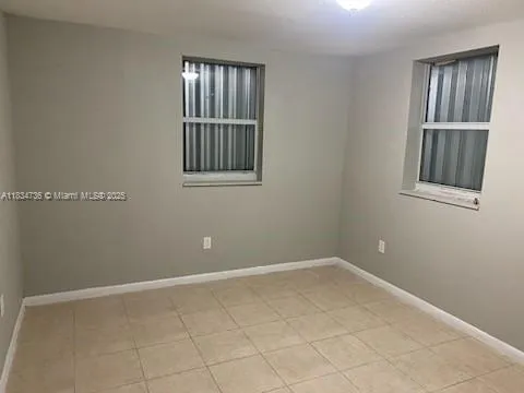 a view of an empty room with windows