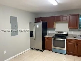 a kitchen with stainless steel appliances granite countertop a refrigerator and a stove