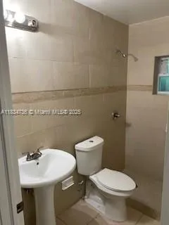 a bathroom with a sink toilet and a mirror