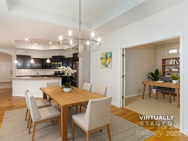 a view of empty room with stairs and a chandelier fan