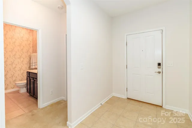 a view of empty room with a fireplace and wooden floor