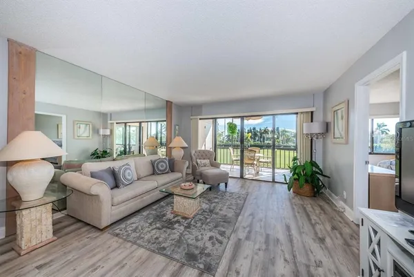 a living room with furniture and wooden floor