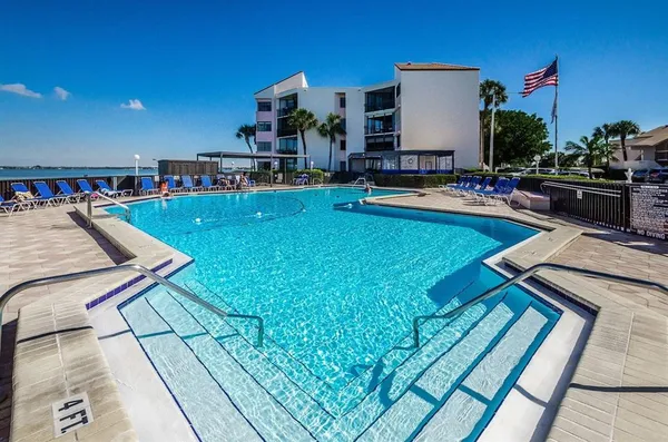 a view of a swimming pool with chairs
