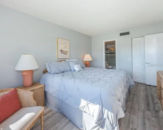 a bedroom with a bed and a lamp