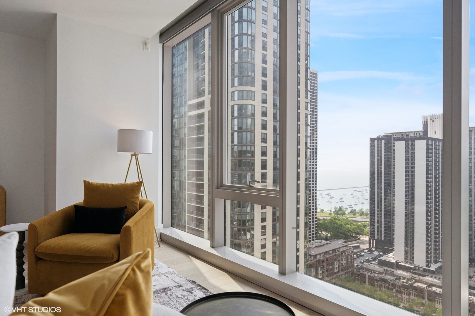 363 East Wacker Drive, Unit 1903 Chicago, IL 60601 - Photo 12 of 39 a living room with furniture and a floor to ceiling window