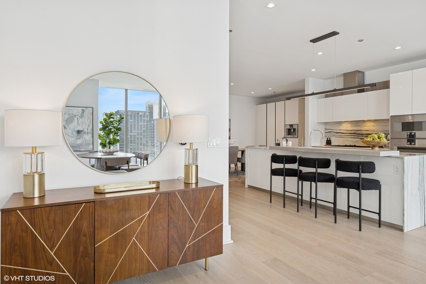 363 East Wacker Drive, Unit 1903 Chicago, IL 60601 - Photo 14 of 39 a living room with stainless steel appliances kitchen island granite countertop a rug a stove and a dining table with wooden floor