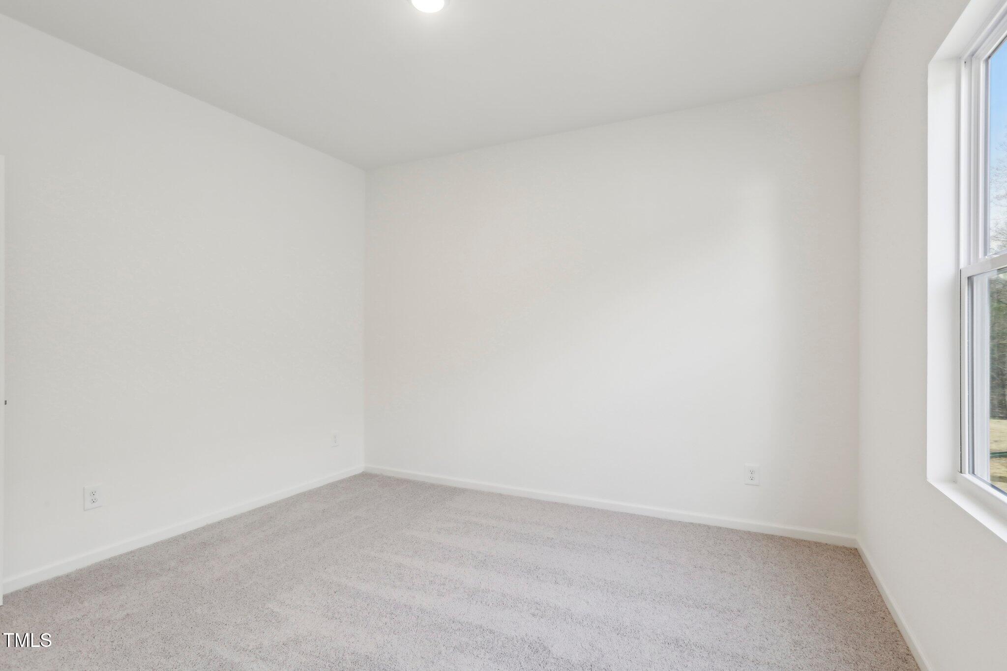 927 Embraer Way Spring Hope, NC 27882 - Photo 40 of 43 a view of an empty room and a window