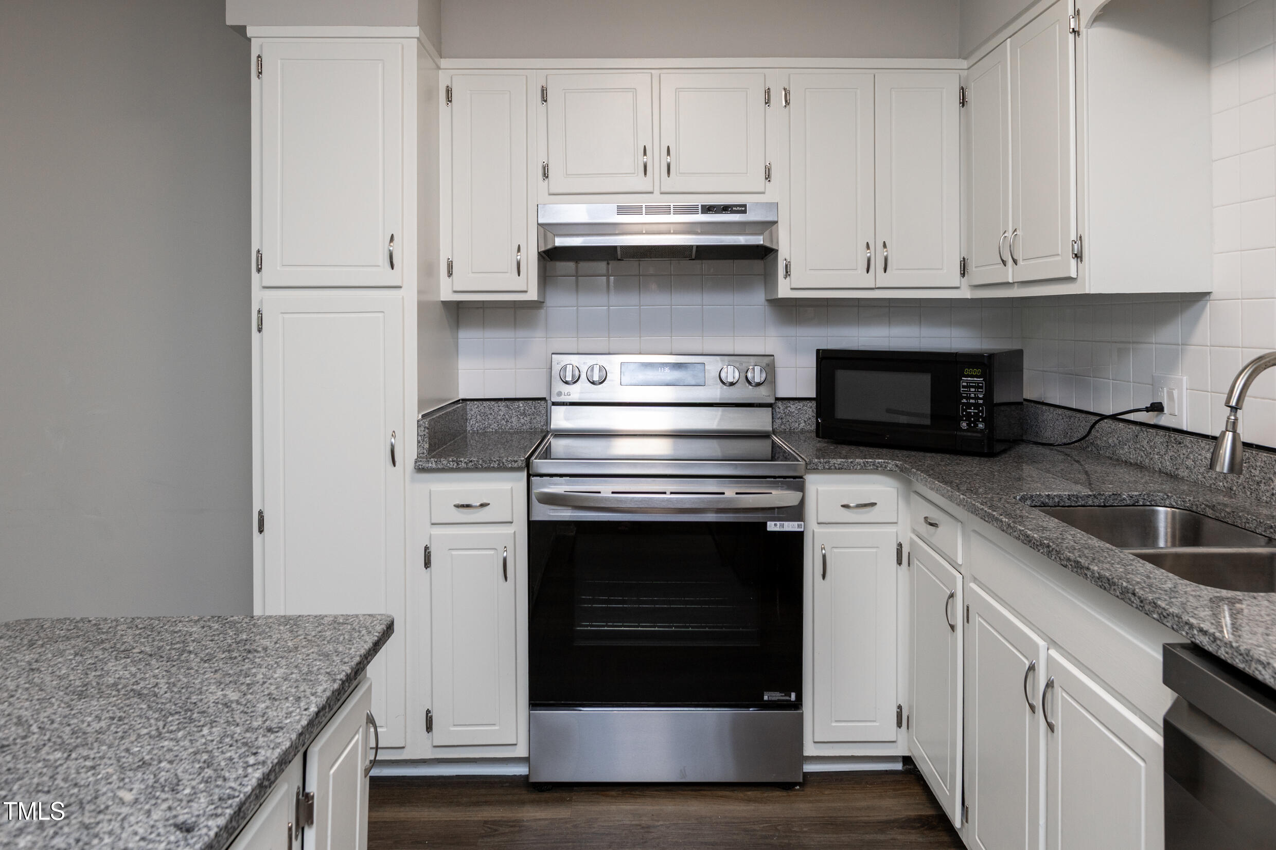 5036 Flint Ridge Place Raleigh, NC 27609 - Photo 11 of 21 a kitchen with granite countertop white cabinets and a stove