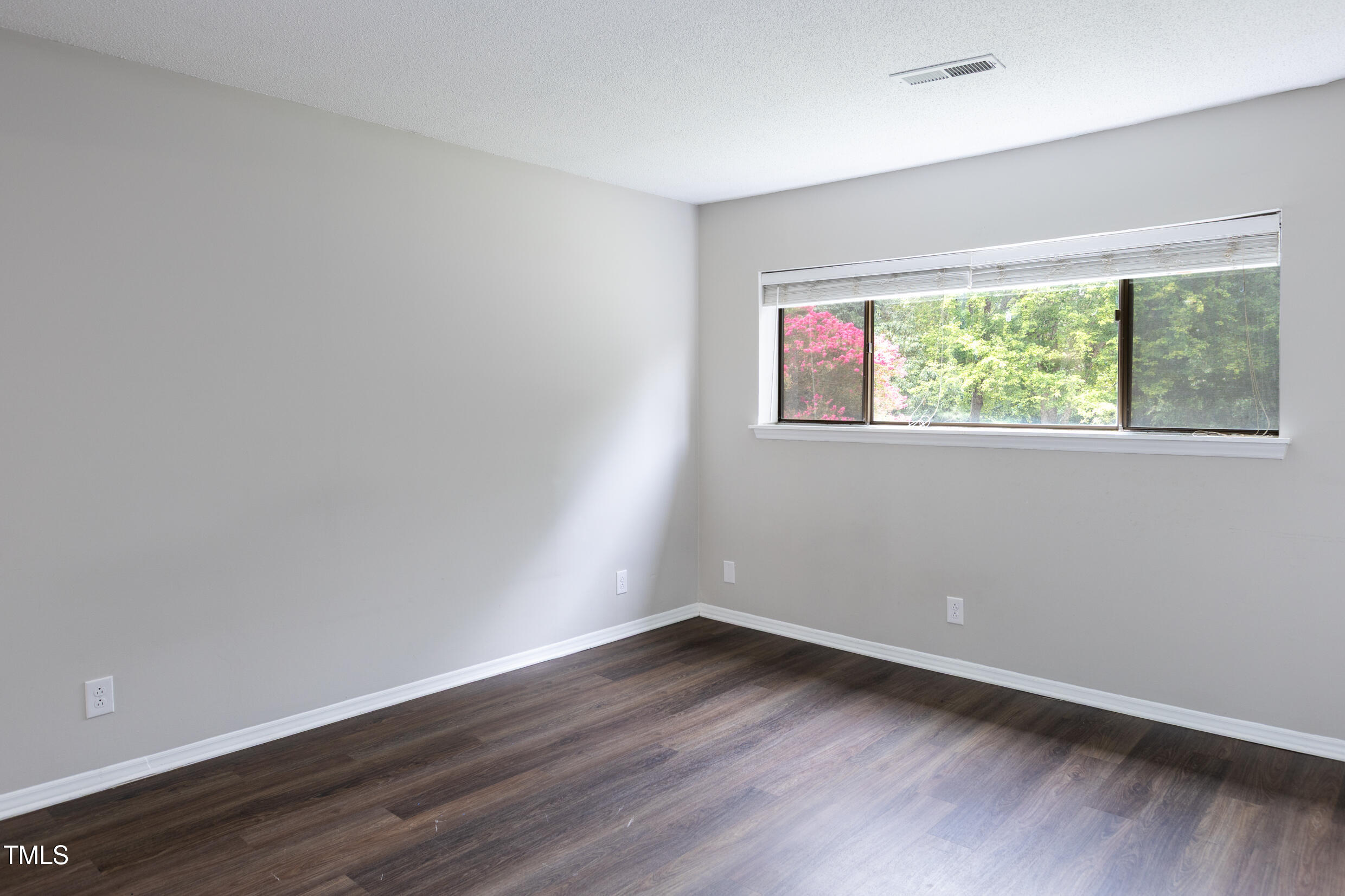 5036 Flint Ridge Place Raleigh, NC 27609 - Photo 14 of 21 wooden floor in an empty room with a window