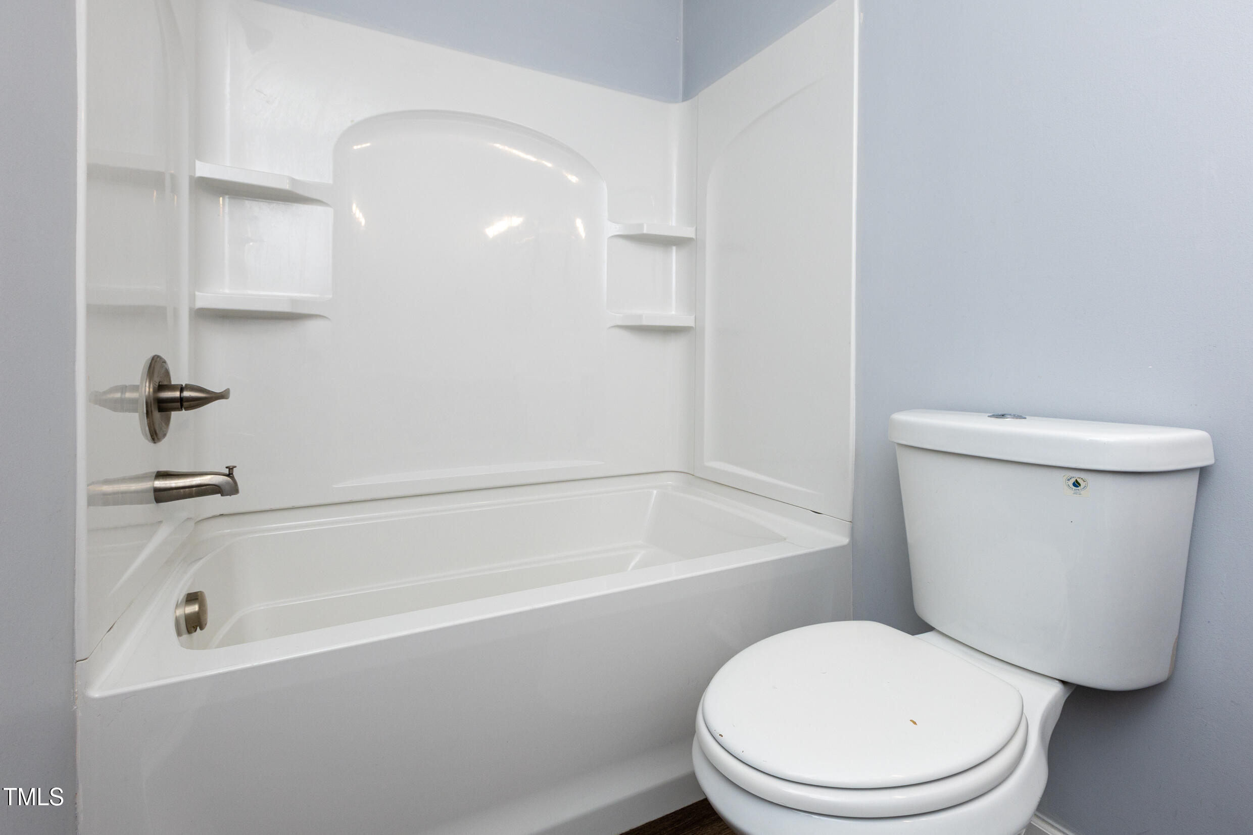 5036 Flint Ridge Place Raleigh, NC 27609 - Photo 17 of 21 a white toilet sitting next to a bath tub