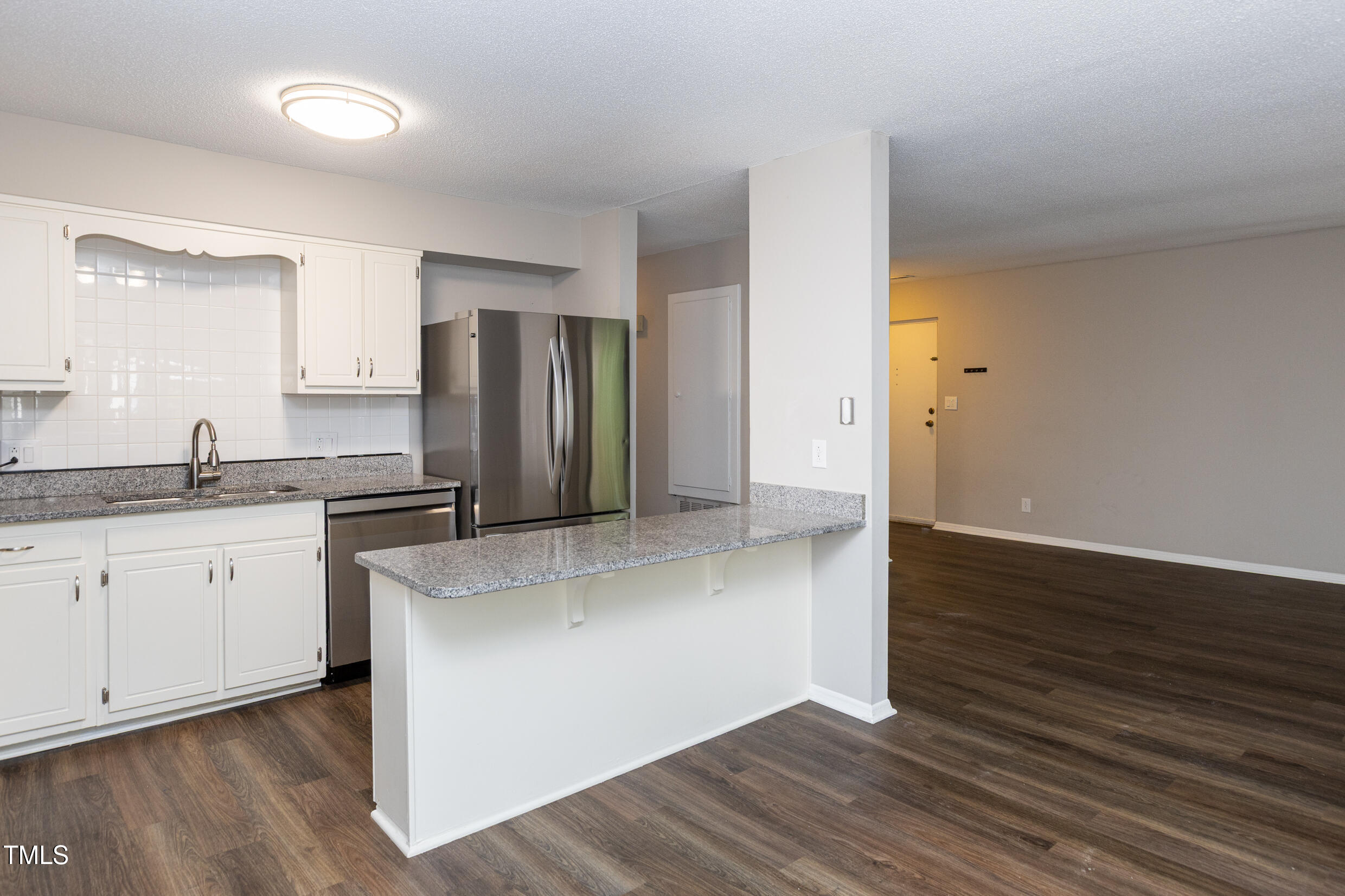 5036 Flint Ridge Place Raleigh, NC 27609 - Photo 9 of 21 a kitchen with stainless steel appliances granite countertop a refrigerator and a sink